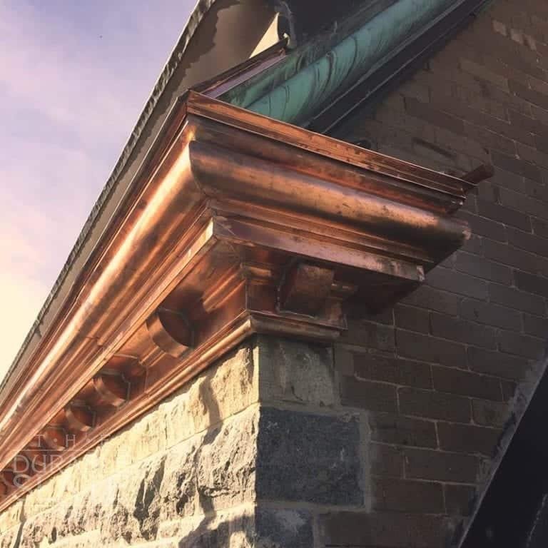 close up of a copper gutter end cap