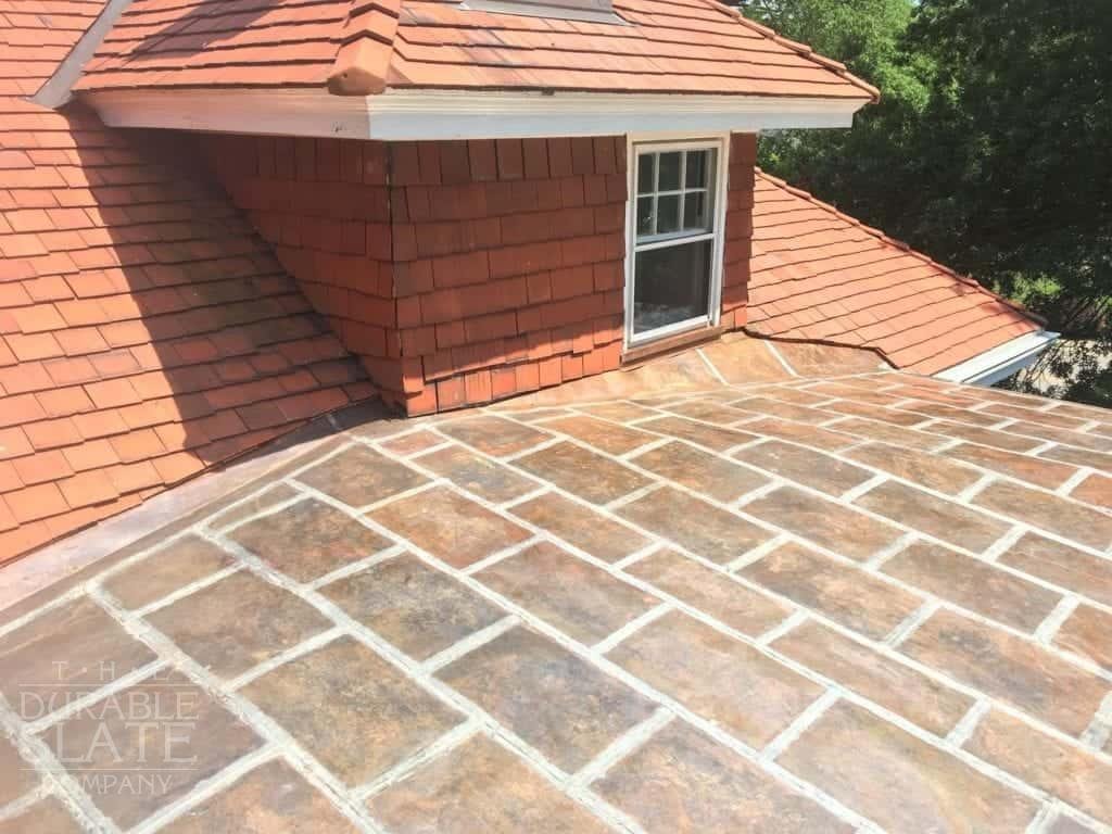 a copper flat lock roof with terra cotta clay-tile roof