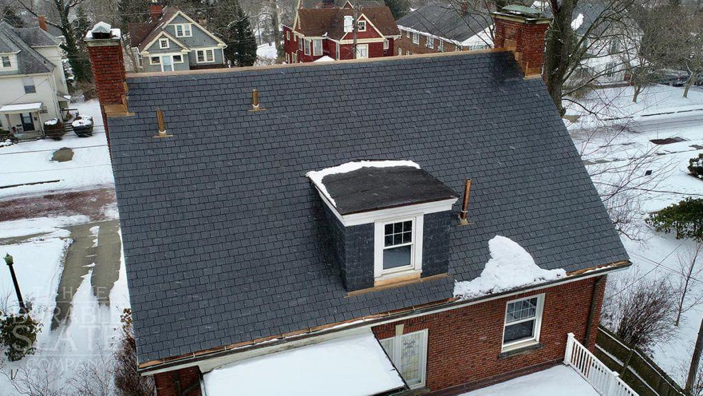 slate roof with copper work and fresh snow in akron ohio