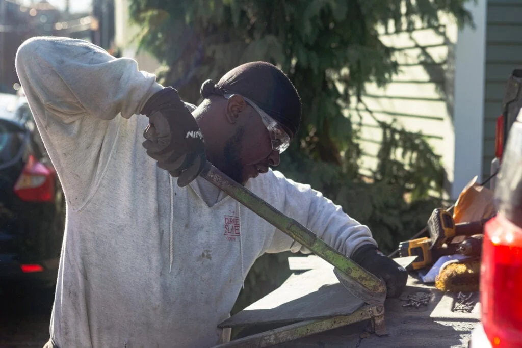 raheem cutting the edge of a slate tile