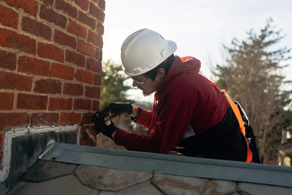 logan working on the flashing of a slate roof