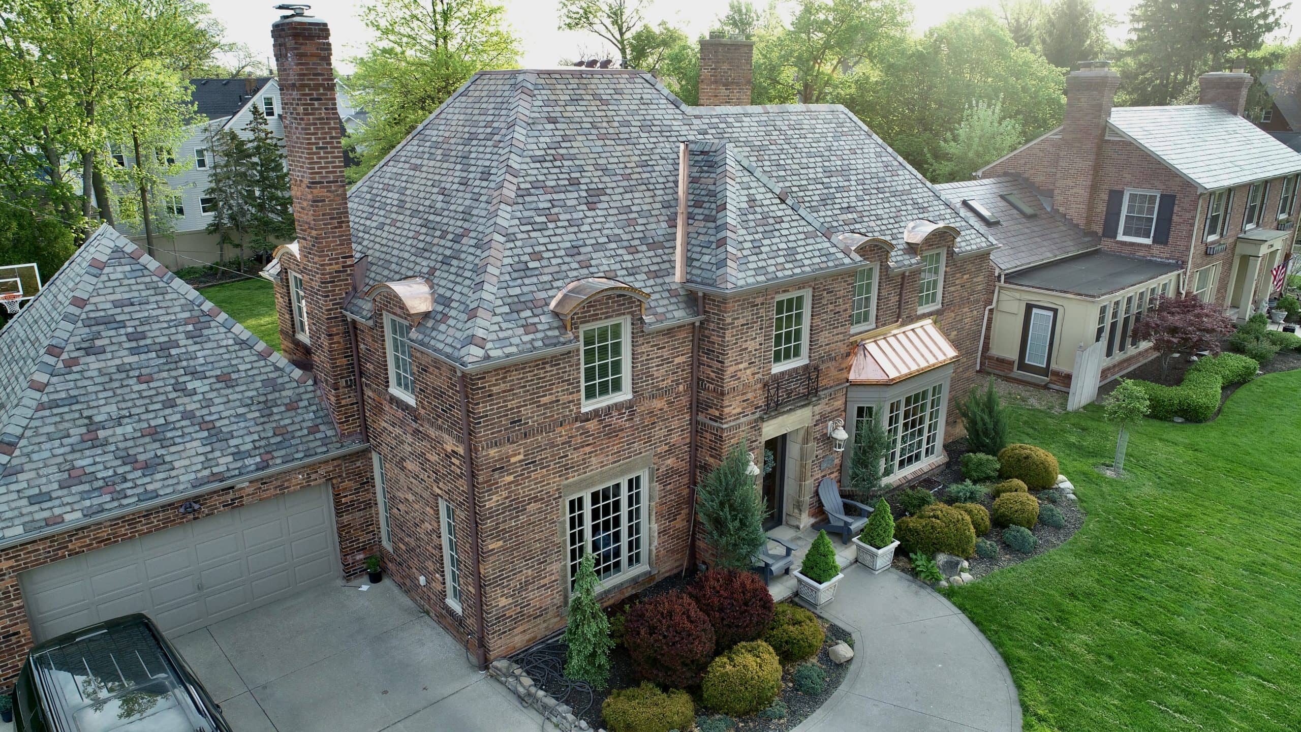 a large brick building with grass in front of a house