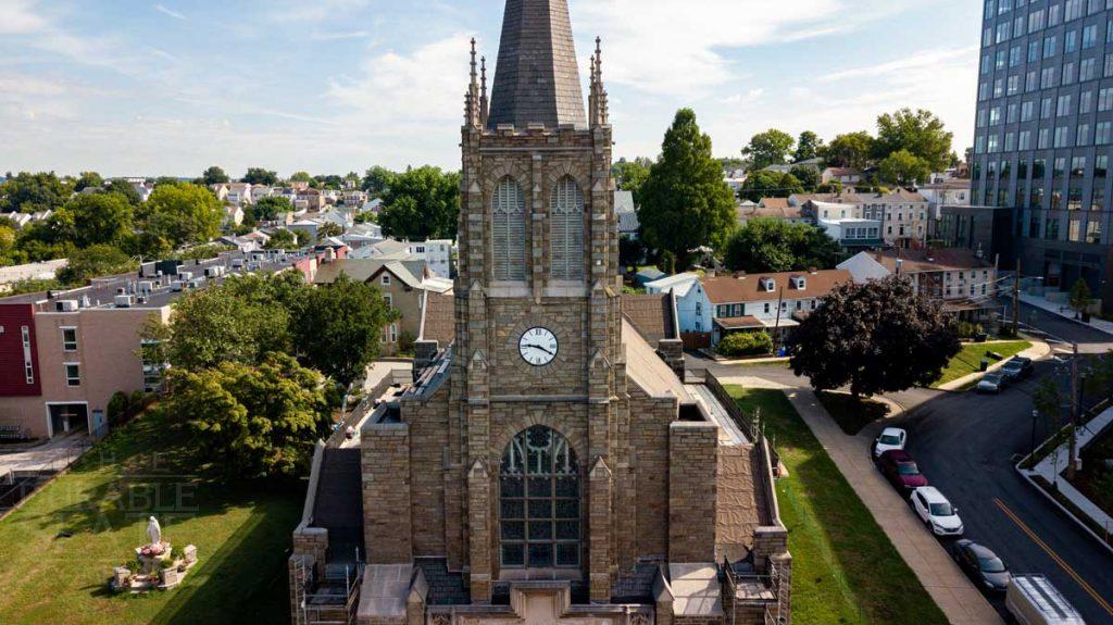 a large brick building with a clock on the tower of the city