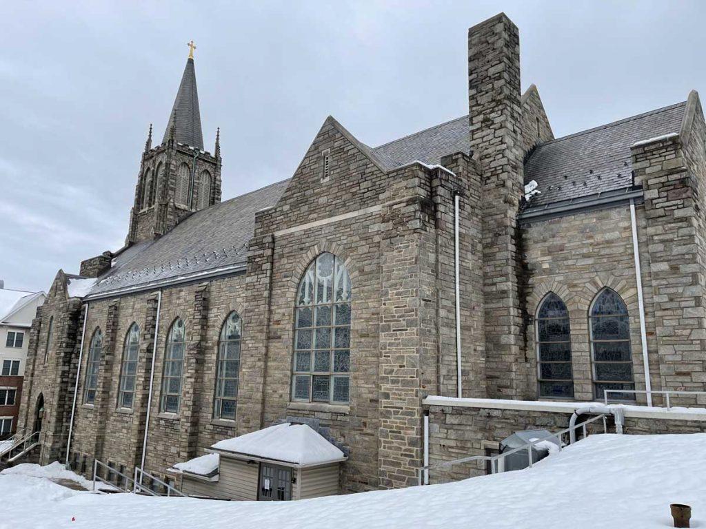 a church in the snow with All Saints Church, Leamington Spa in the background