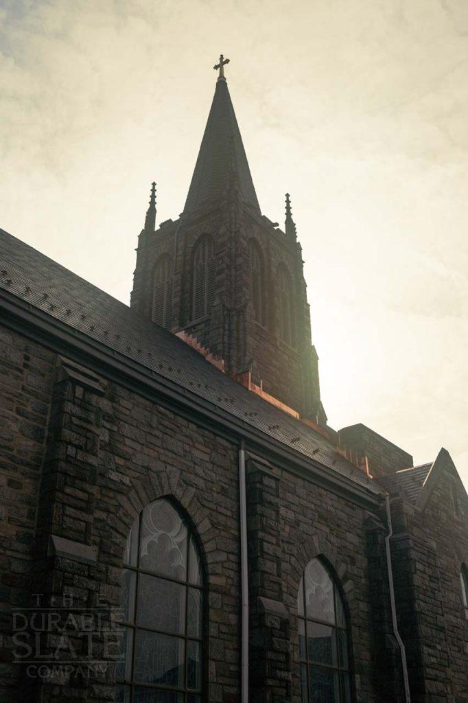 a large tall tower with a clock on the side of a building