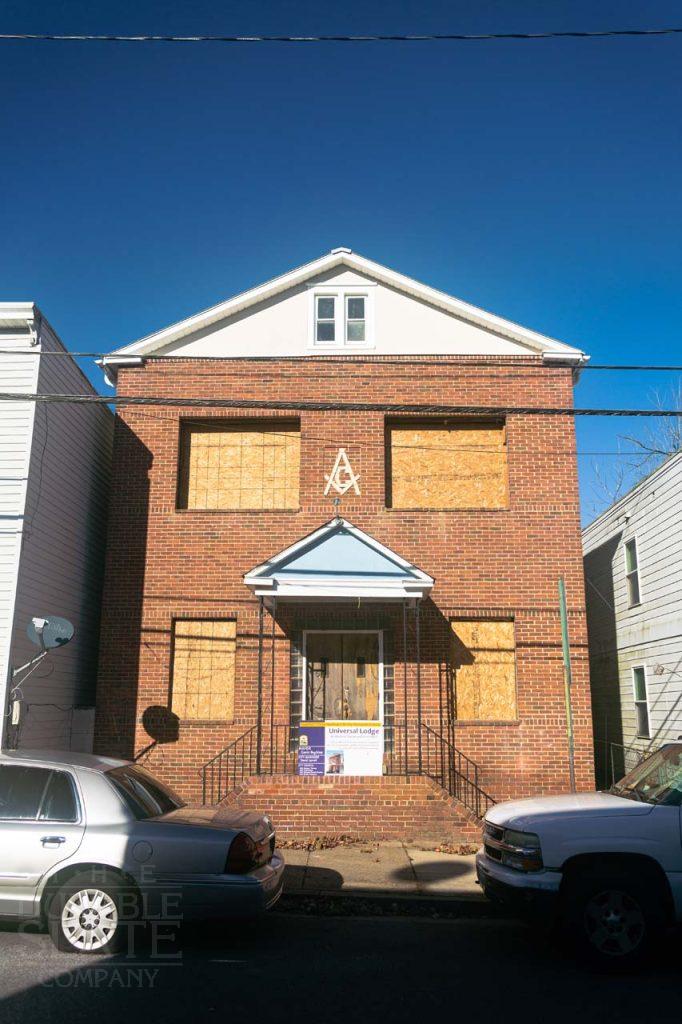 a car parked in front of a brick building