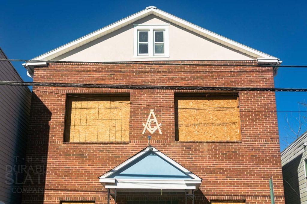 a sign in front of a brick building