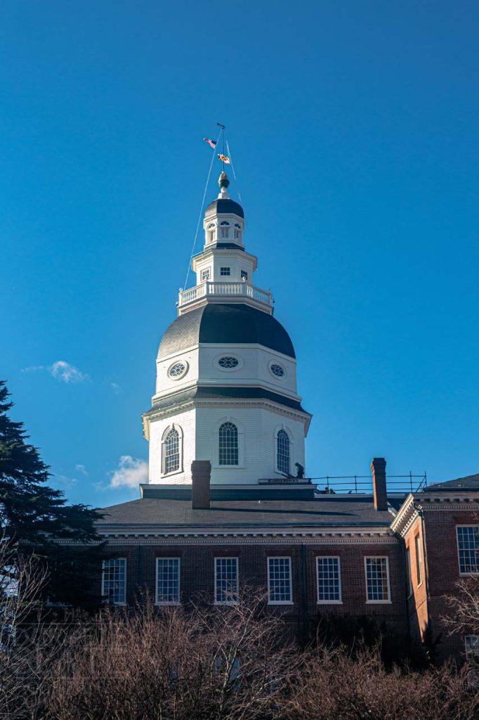 a large brick building with a tower in the background