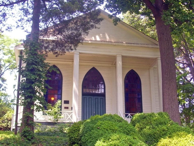 a house with bushes in front of a building