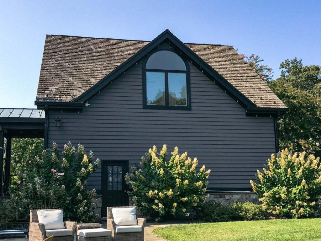 a house with bushes in front of a building