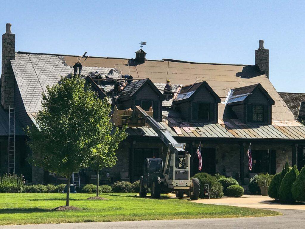 a large brick building with grass in front of a house