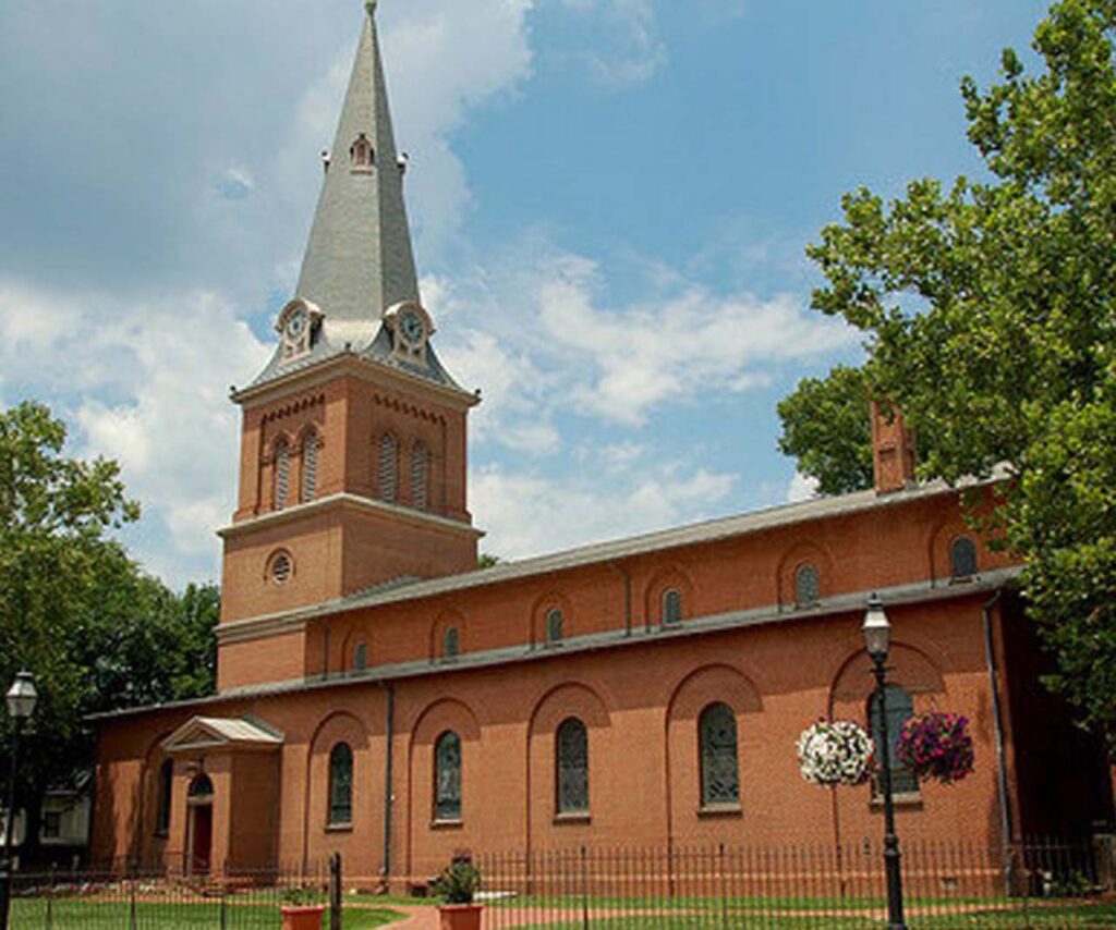 a church with a clock on the side of a building